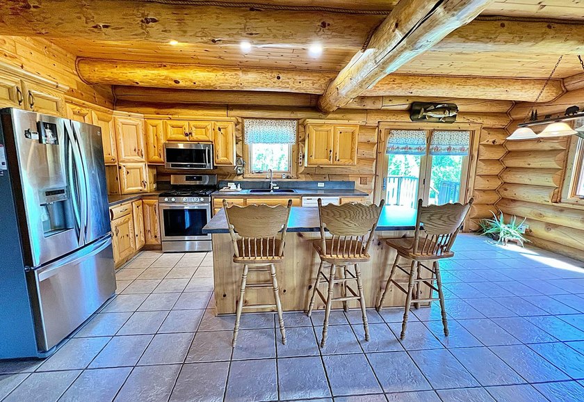 Authentic log cabin retreat on 80 picturesque acres featuring a - photo 6