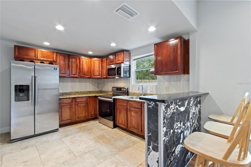 This meticulously renovated property features a new, detached - photo 5