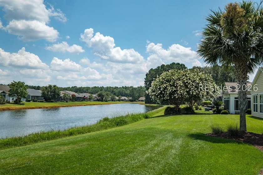 Set on a large premium lot with peaceful lagoon views, timeless - photo 3
