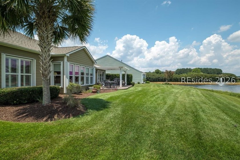 Set on a large premium lot with peaceful lagoon views, timeless - photo 4