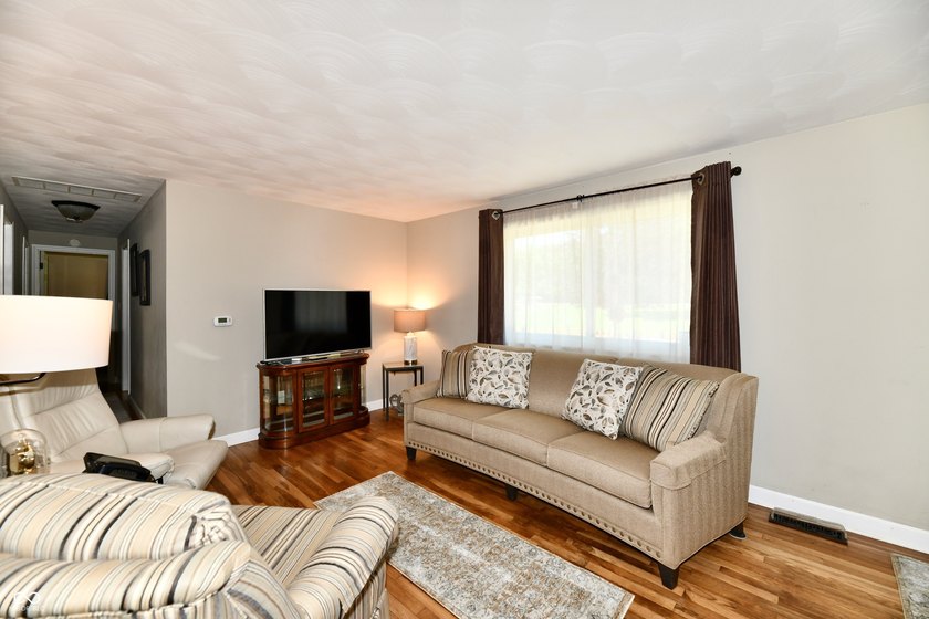Tucked away on a quiet lot that COMBINES a spacious lawn with a - photo 8