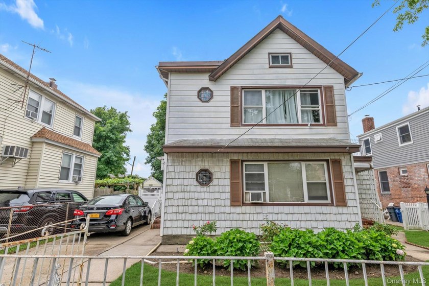 This detached two-family features a 3-bedroom/1-bathroom unit - photo 2