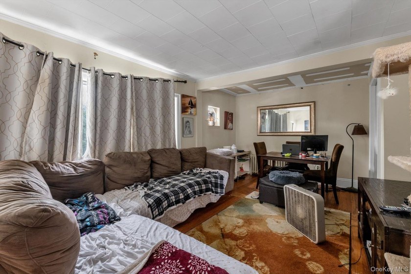This detached two-family features a 3-bedroom/1-bathroom unit - photo 4