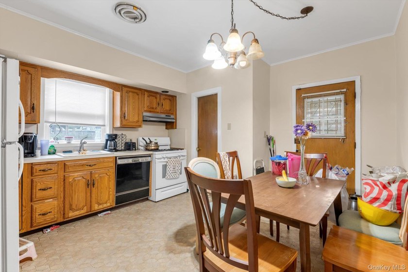 This detached two-family features a 3-bedroom/1-bathroom unit - photo 5