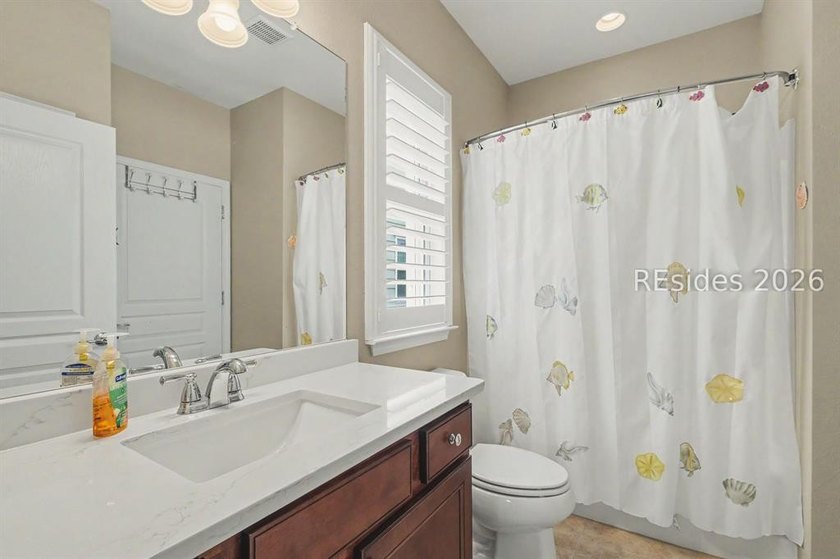 Set on a large premium lot with peaceful lagoon views, timeless - photo 24