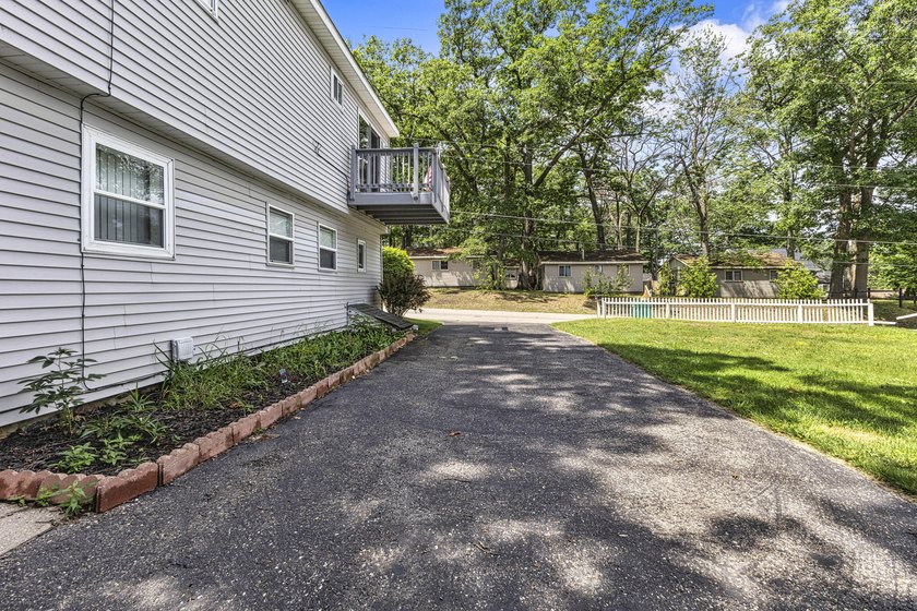 Wake up to beautiful views of Houghton Lake from the spacious - photo 35
