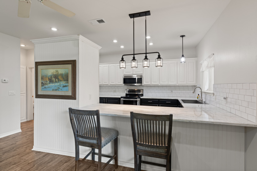 Kitchen with counter height seating. - photo 6