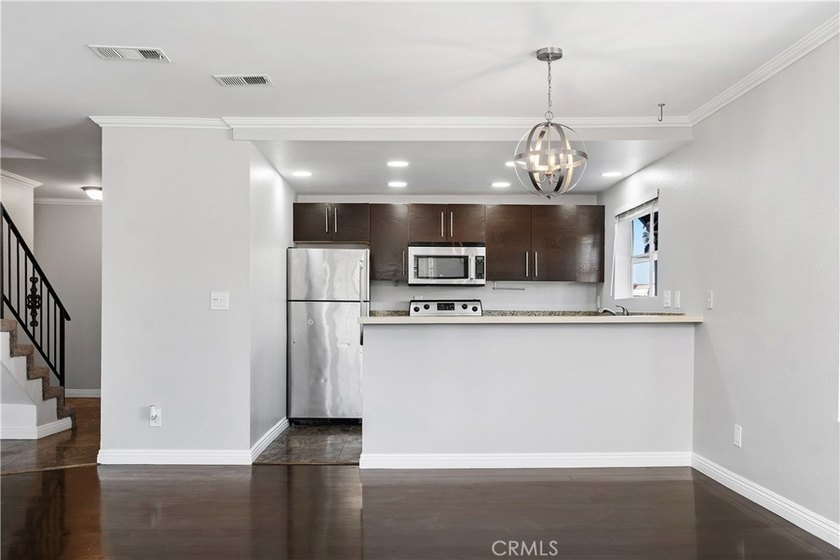 This two-story, townhouse-style condominium offers two primary - photo 7
