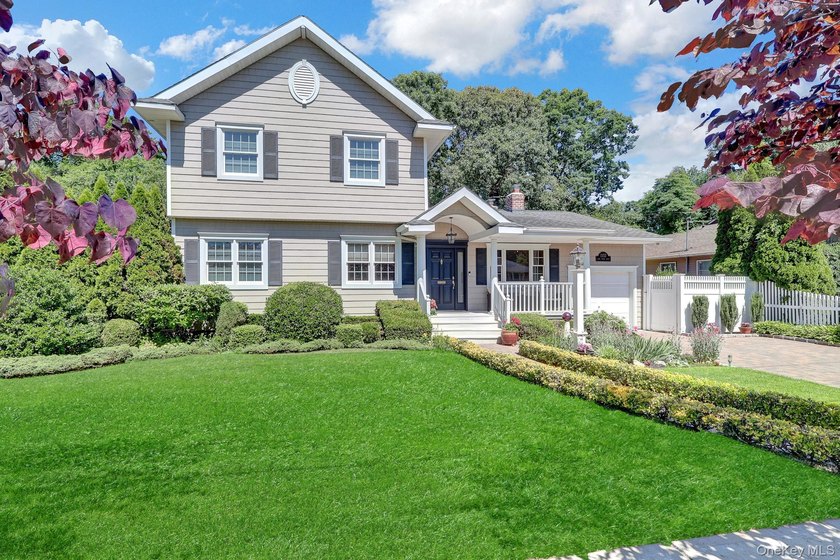 Welcome to this beautifully expanded ranch nestled in one of the - photo 2