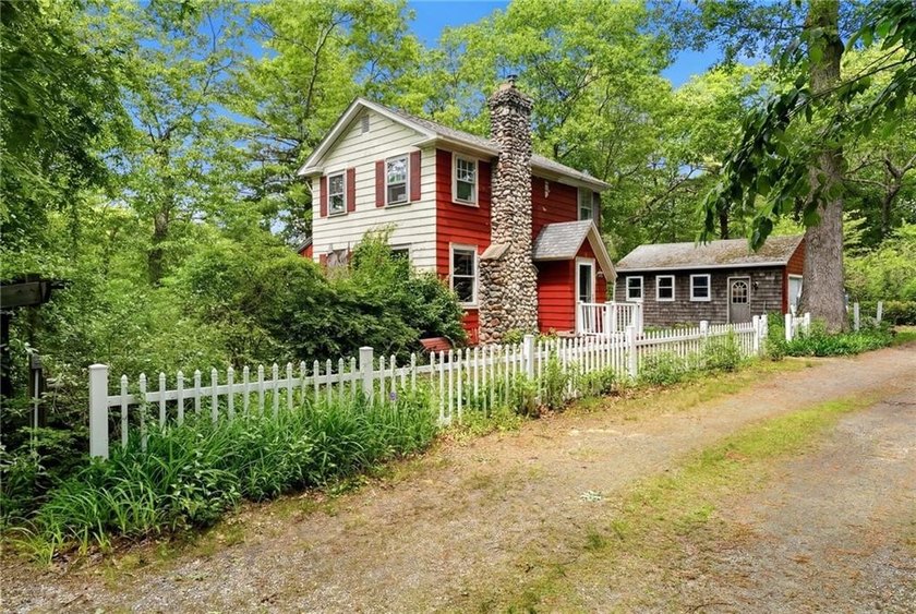 Set on nearly an acre in North Kingstown, this 3-bedroom, 1-bath - photo 2