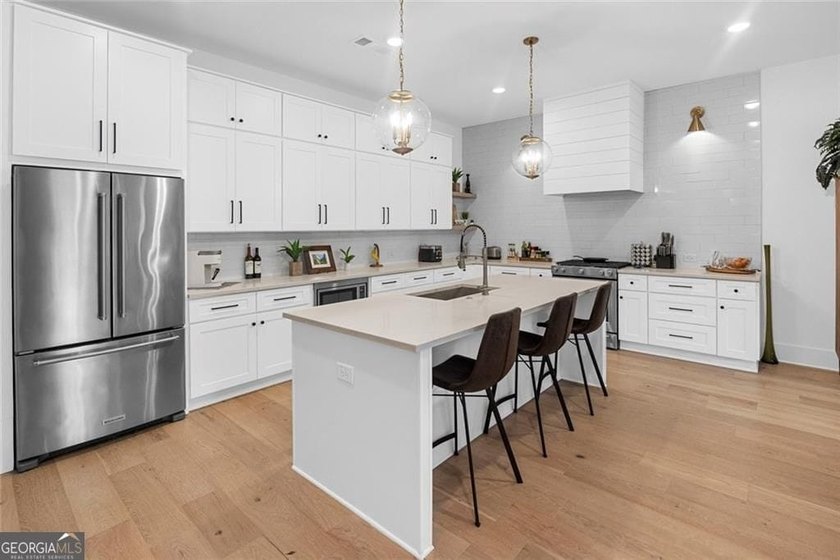 Tucked in the heart of Bridgemill, this luxury townhome lives - photo 4