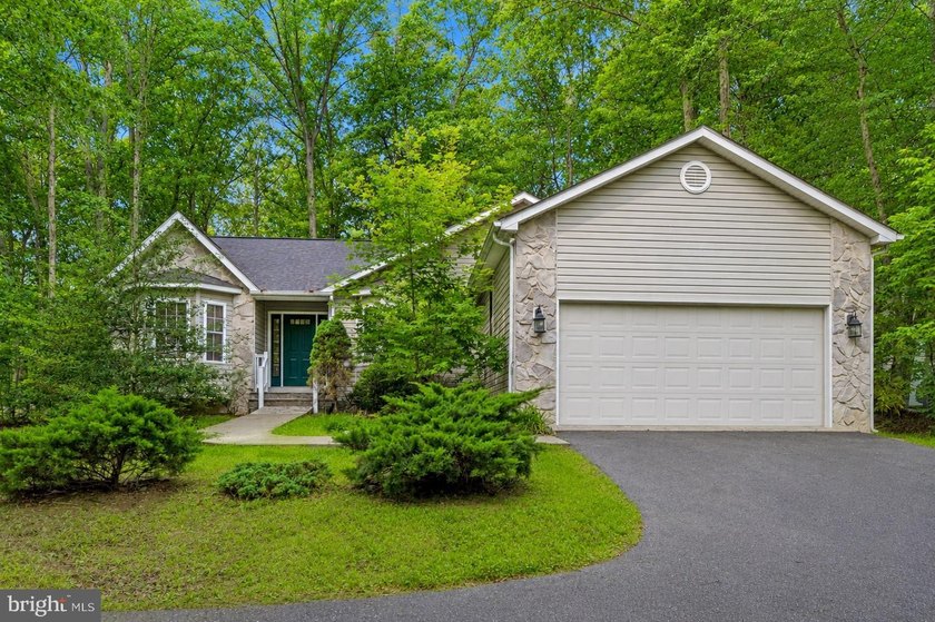 Nestled among mature green trees in the gated Lake of the Woods - photo 2