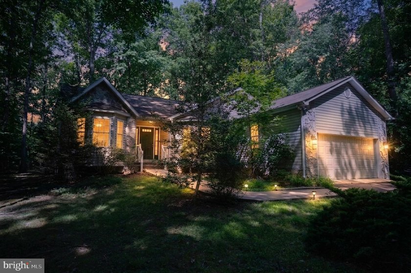 Nestled among mature green trees in the gated Lake of the Woods - photo 3