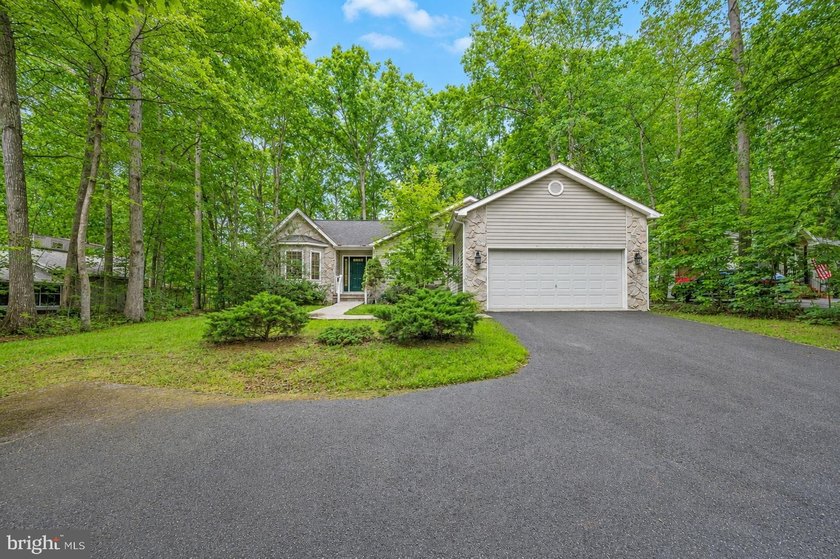 Nestled among mature green trees in the gated Lake of the Woods - photo 4