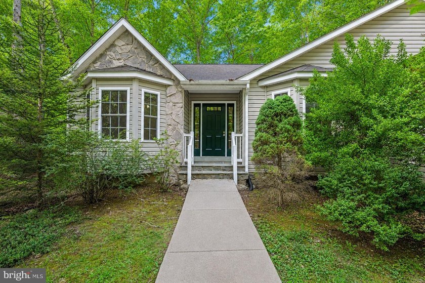 Nestled among mature green trees in the gated Lake of the Woods - photo 5