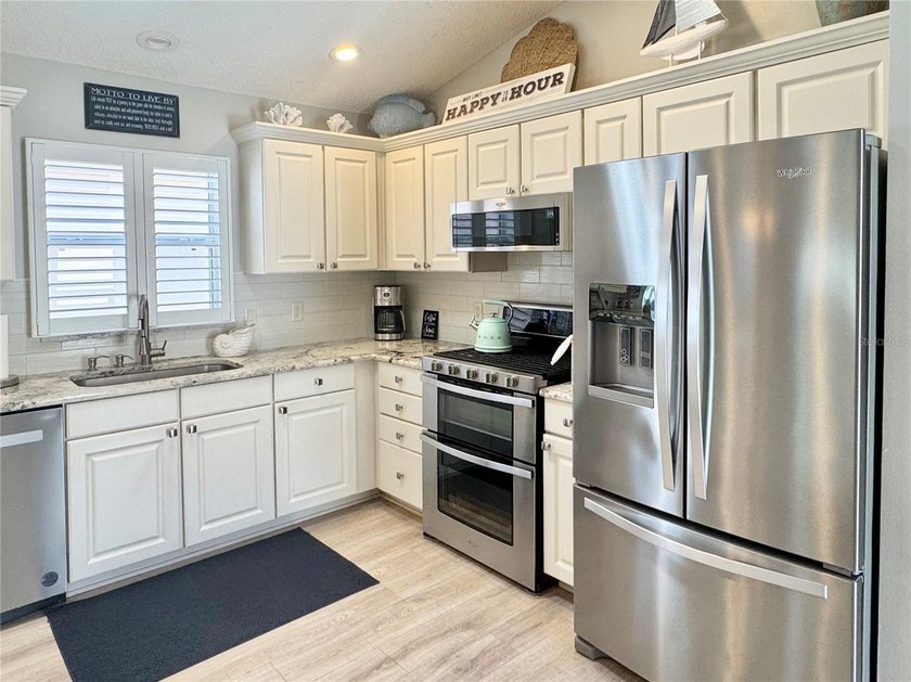 NO BOND~ 2024 ROOF~ NO CARPET~PLANTATION SHUTTERS THROUGHOUT~ - photo 6
