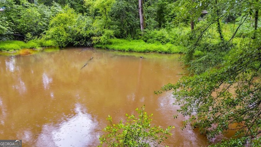 Rare 9.5-Acre Haven with Spring-Fed Pond, Multiple Structures &amp; - photo 13