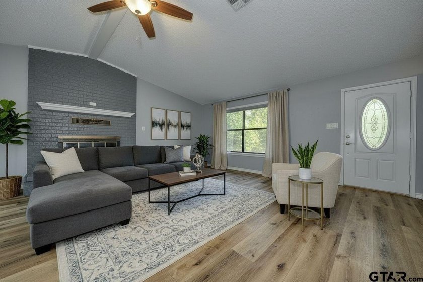 Nestled on a quiet street, this inviting residence blends - photo 2