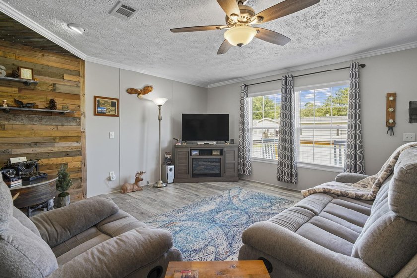 Three-bedroom, two-bathroom, single-story manufactured home with - photo 3