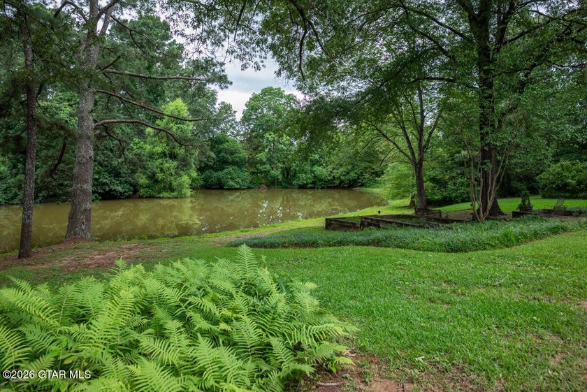 Set on 4.04 acres with pond frontage, this custom-built - photo 42