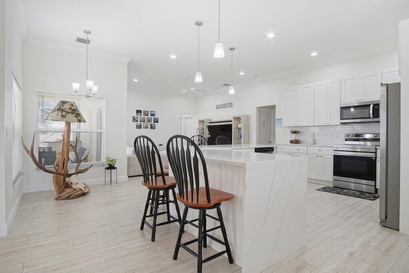 This stunning pool home has it all! Gorgeous plank tile flooring - photo 7