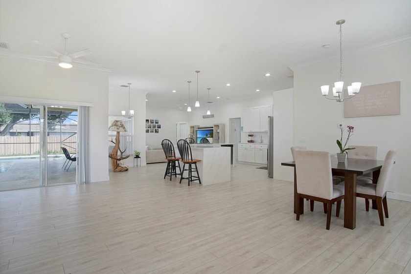 This stunning pool home has it all! Gorgeous plank tile flooring - photo 8