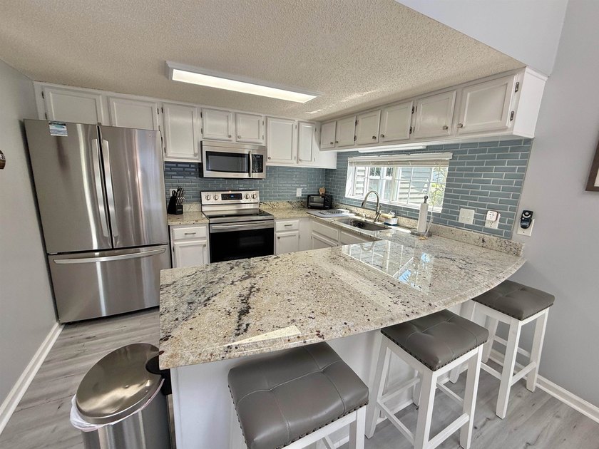 Updated townhome with new grey weathered-looking LVP flooring - photo 10