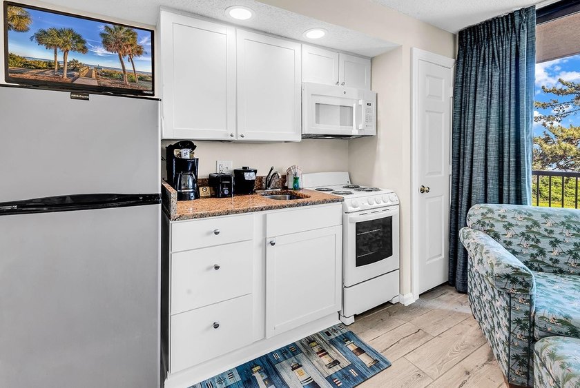 Welcome to Unit 207 at Beach Colony Resort, a charming 1-bedroom - photo 15