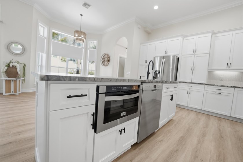 Located in the gated Jupiter Key community just steps from the - photo 17