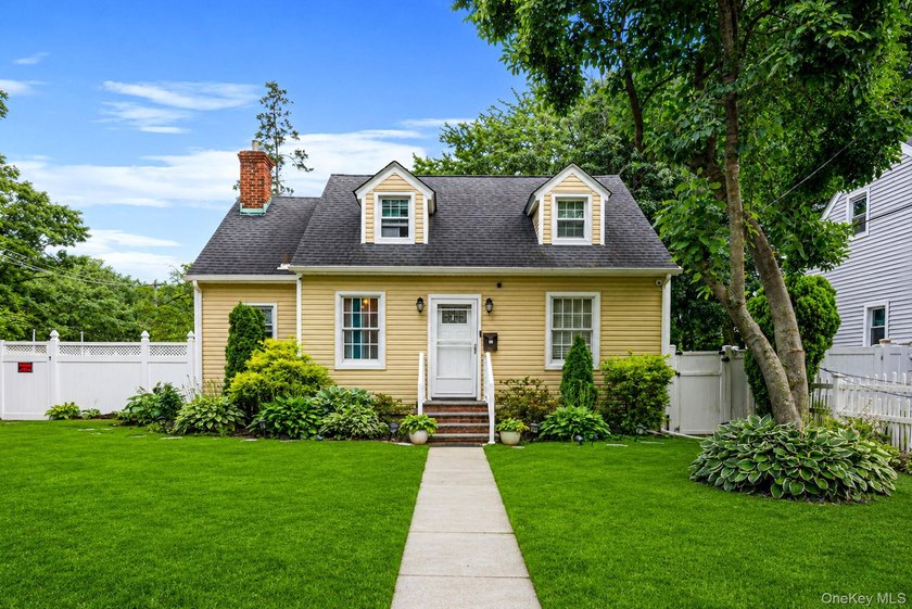Welcome to this charming 4-bedroom, 2-bath Cape Cod situated on - photo 2