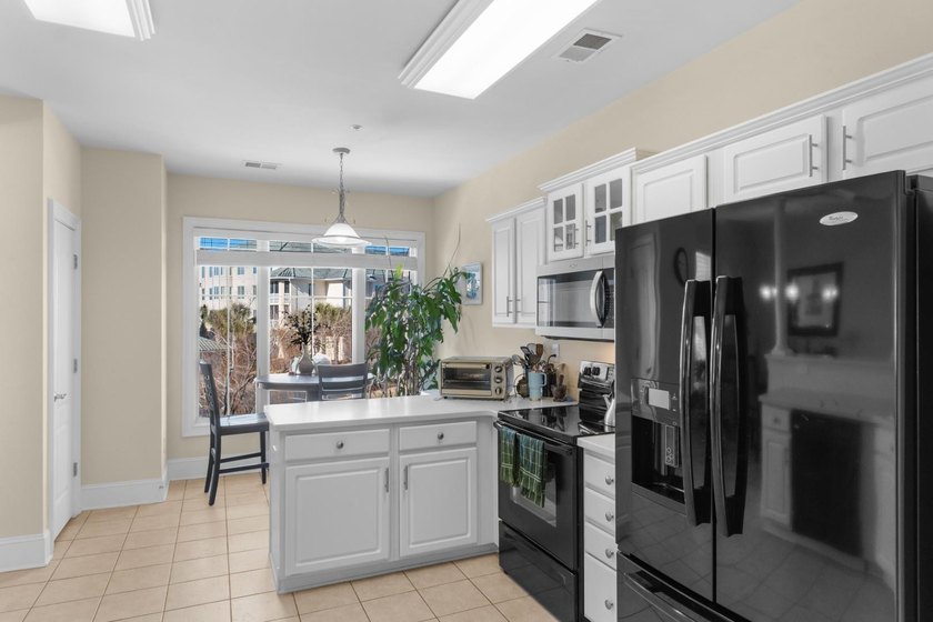 Sunlight pours into this bright, open 3-bedroom, 2-bath end-unit - photo 7