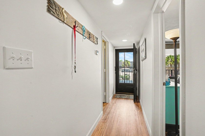 Just a short walk to the beach, this updated second-floor condo - photo 3