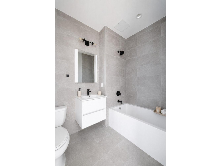 Welcome to 12 Lawton Street, a seven-unit condominium in the - photo 3
