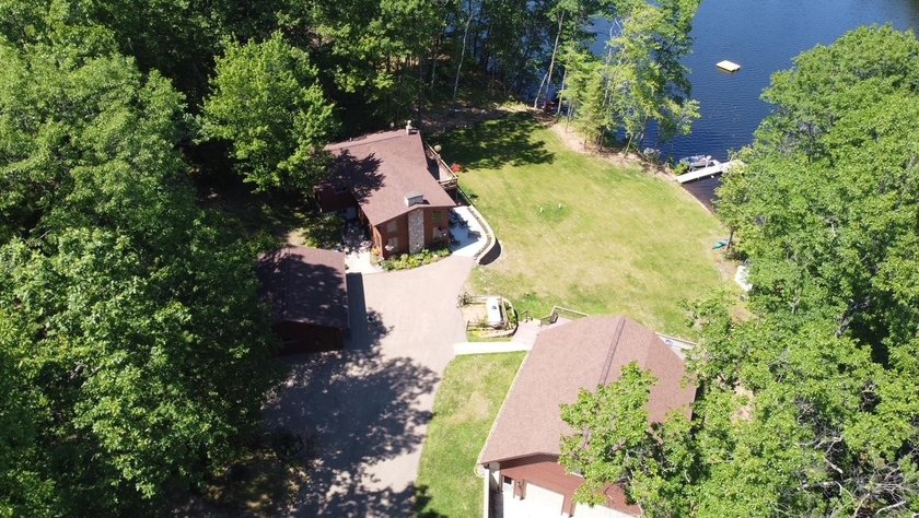 Set on a beautifully wooded 1.7-acre lot with 393 feet of sandy - photo 4