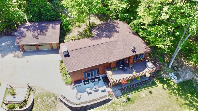 Set on a beautifully wooded 1.7-acre lot with 393 feet of sandy - photo 6