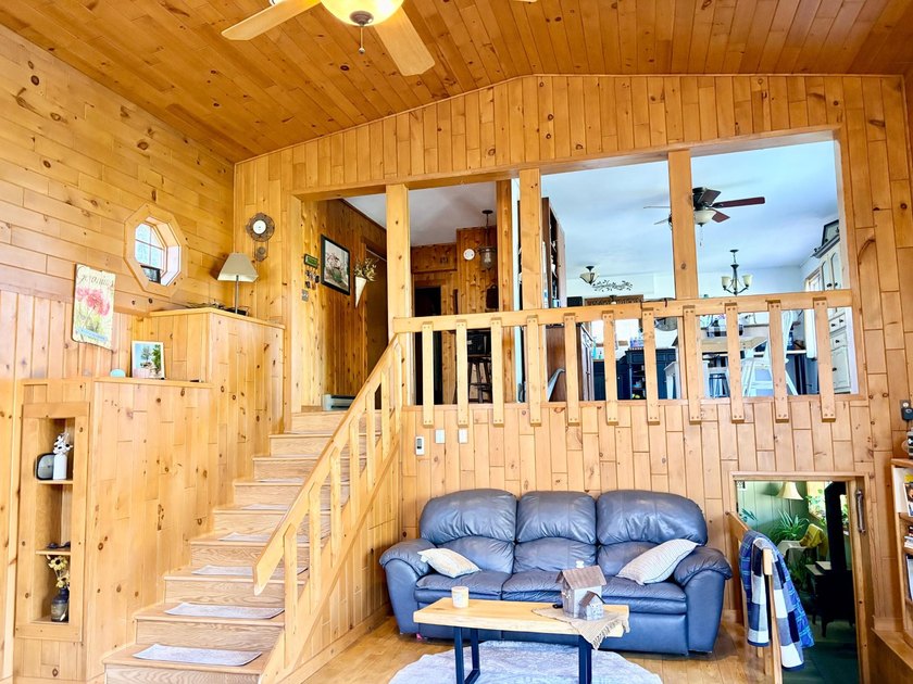 Set on a beautifully wooded 1.7-acre lot with 393 feet of sandy - photo 9