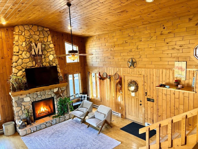 Set on a beautifully wooded 1.7-acre lot with 393 feet of sandy - photo 10