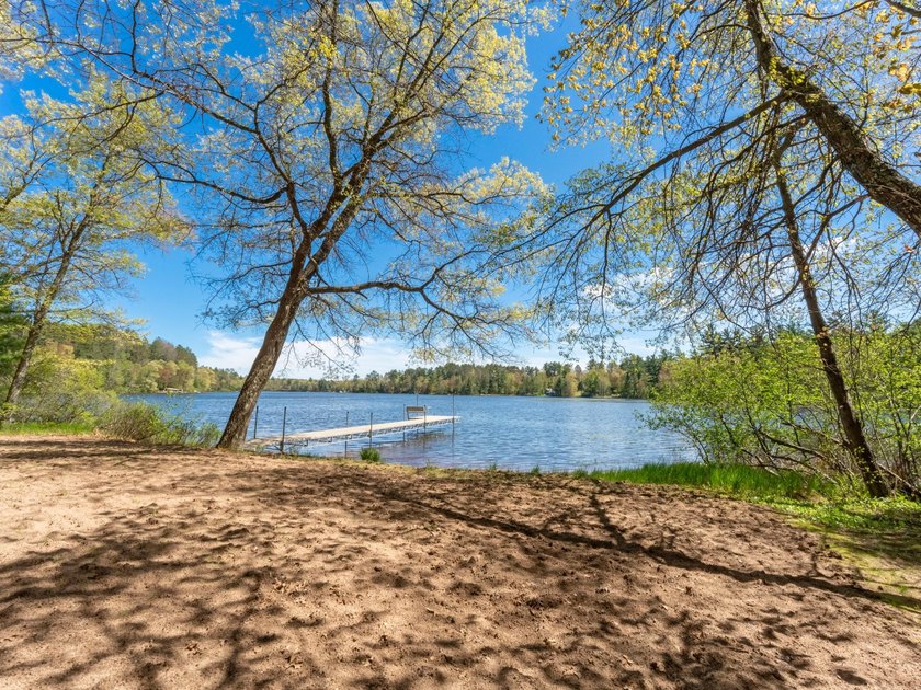 Tucked beneath a canopy of mature Northwoods hardwoods and pines - photo 5