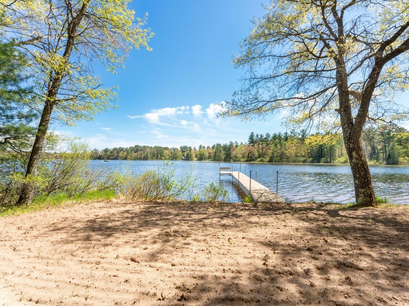 Tucked beneath a canopy of mature Northwoods hardwoods and pines - photo 9
