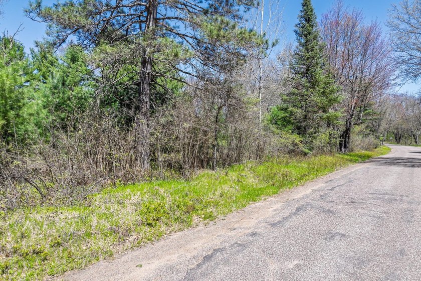 This 1.16-acre wooded parcel with 210 feet of frontage on the - photo 3