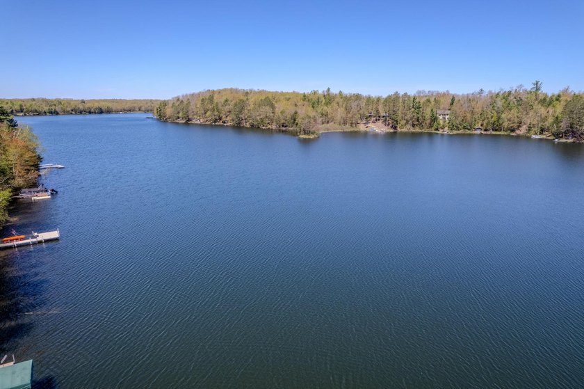 Nestled on a wooded lot on beautiful 204 AC BOOTH lake, this - photo 2