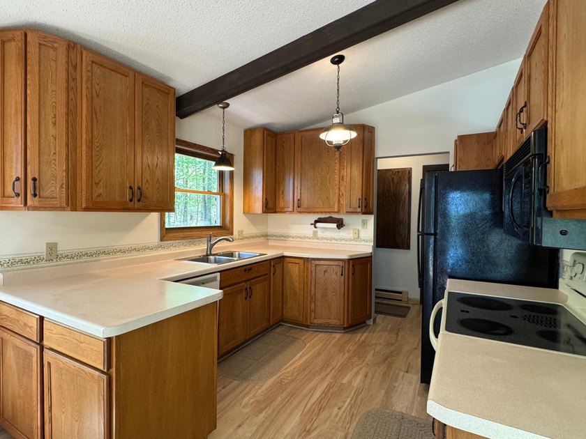 Nestled on a wooded lot on beautiful 204 AC BOOTH lake, this - photo 4