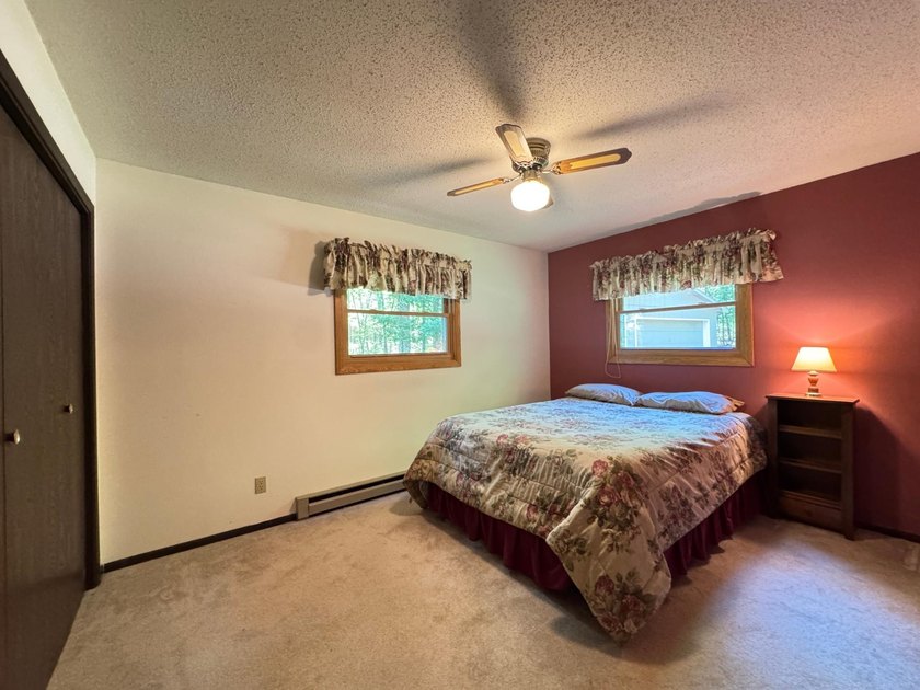 Nestled on a wooded lot on beautiful 204 AC BOOTH lake, this - photo 6
