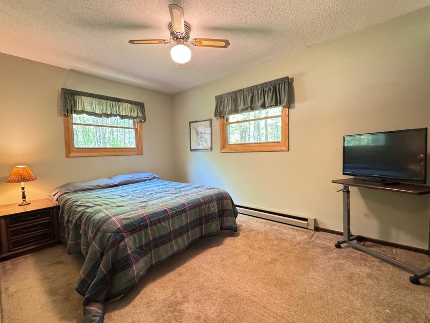 Nestled on a wooded lot on beautiful 204 AC BOOTH lake, this - photo 8