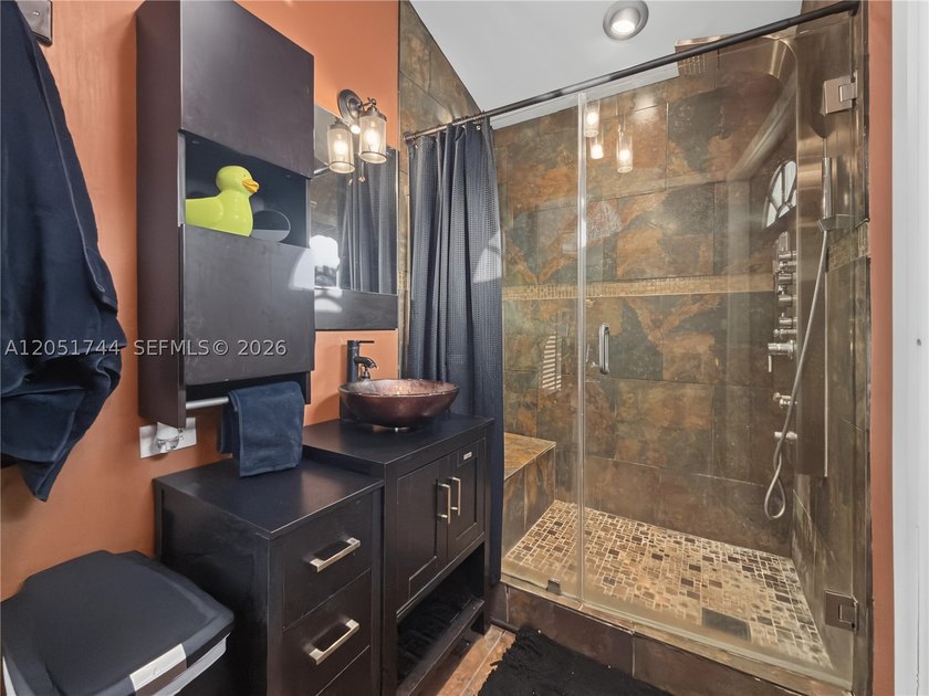 Tucked behind a private, palm-lined entrance in sought-after - photo 29