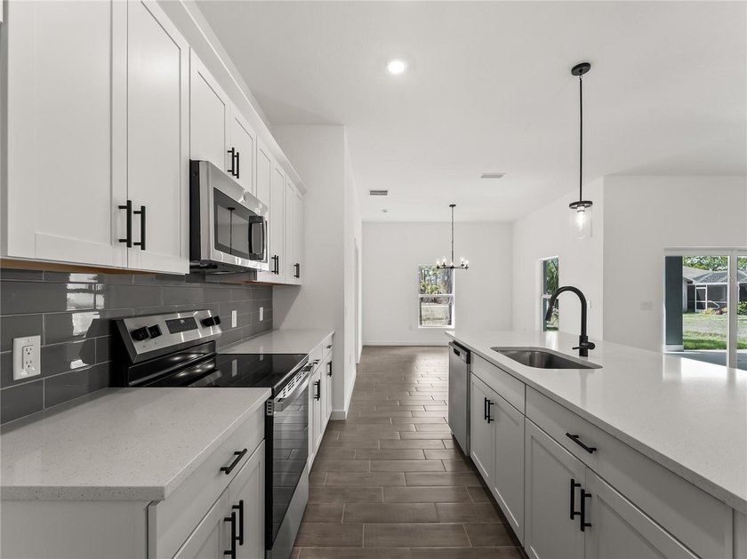 Tile throughout. Quartz countertops. Impact windows. Paver - photo 7