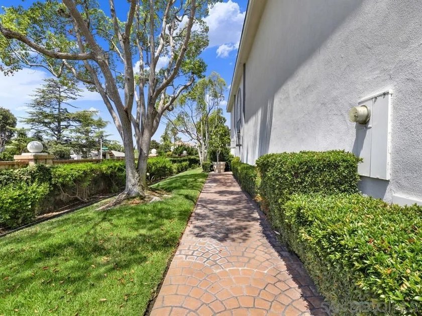 Nestled on a private corner lot within the prestigious gated - photo 8