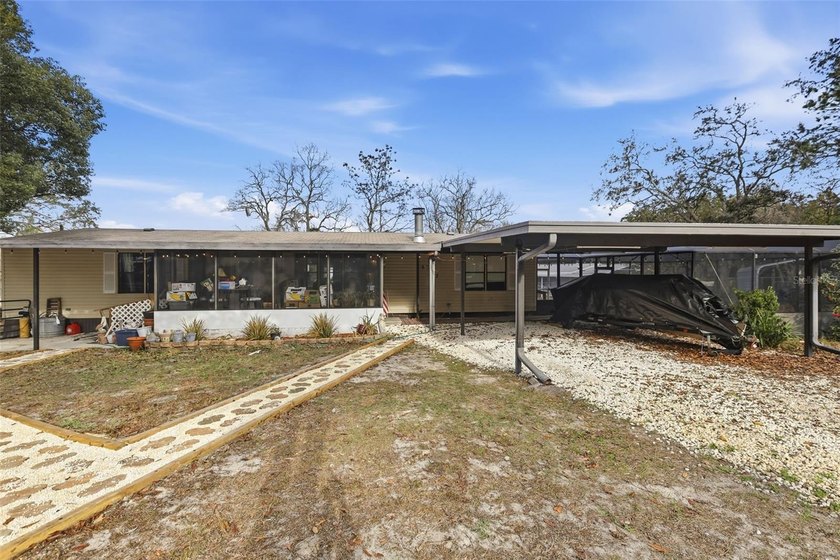 Set on just over half an acre, this 1989 double-wide mobile home - photo 3