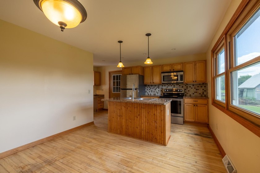 Set on nearly 25 acres along the scenic Deerskin River in Phelps - photo 4