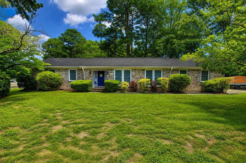 Situated on a spacious corner lot surrounded by mature trees - photo 2